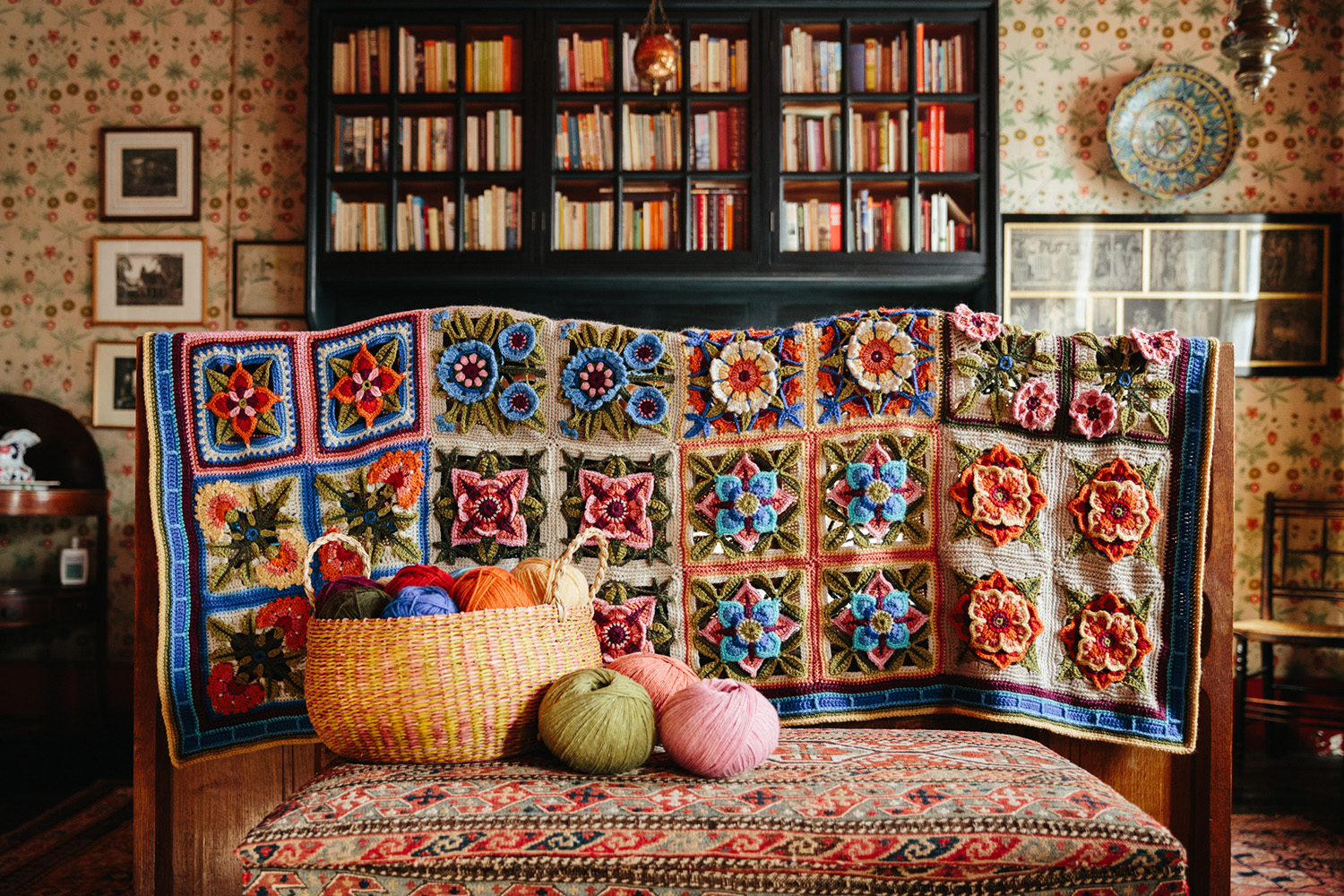 Detailed floral crochet blanket and yarn basket – perfect for your next crochet-along project.
